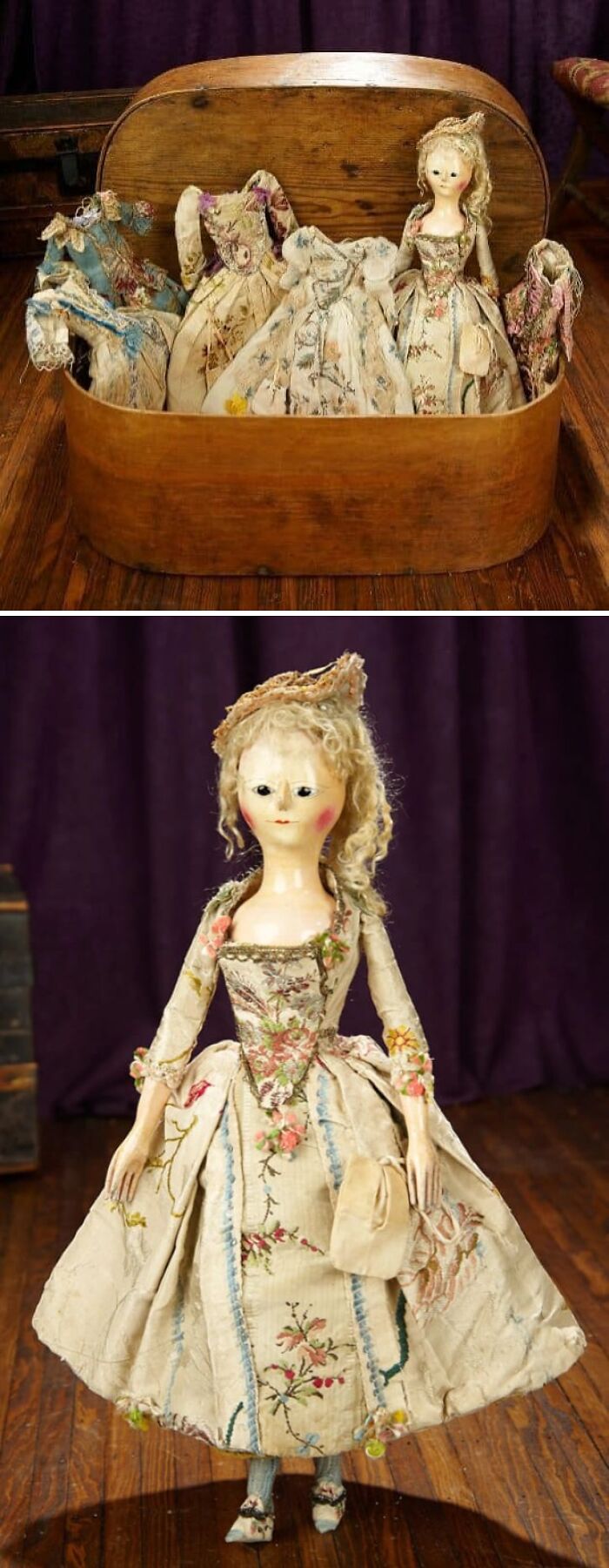 Vintage doll with embroidered dress standing on wooden floor, surrounded by old fabric dresses in a wooden box, old photos capturing culture.