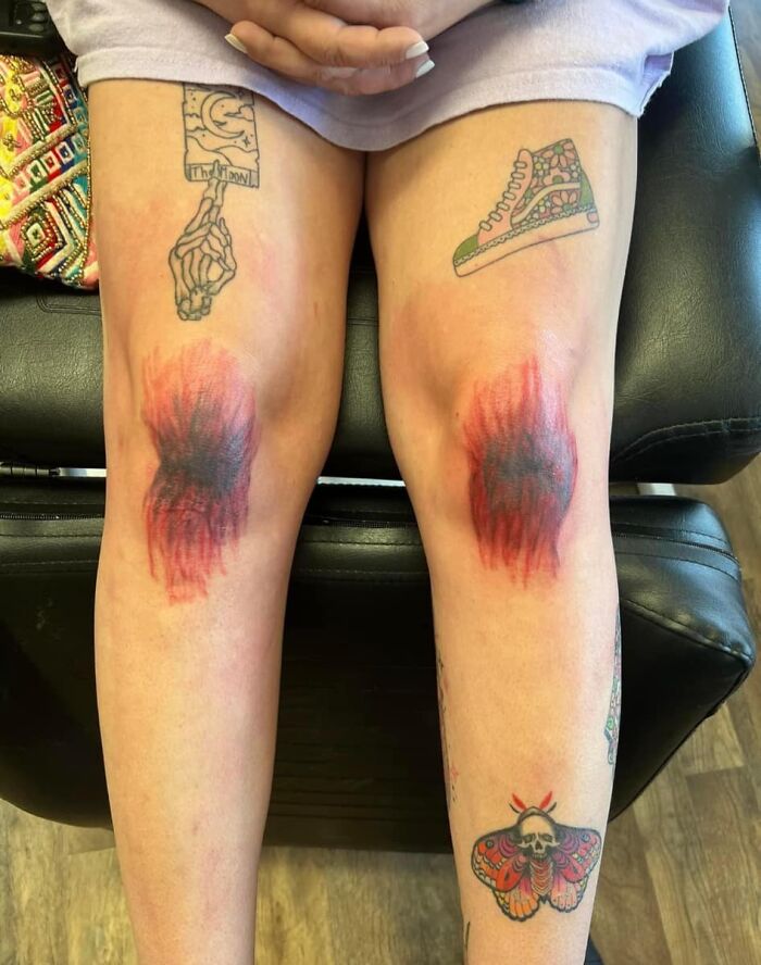 Close-up of legs with worst tattoos showing blurred and red ink resembling bruises, part of a group focused on bad tattoos.