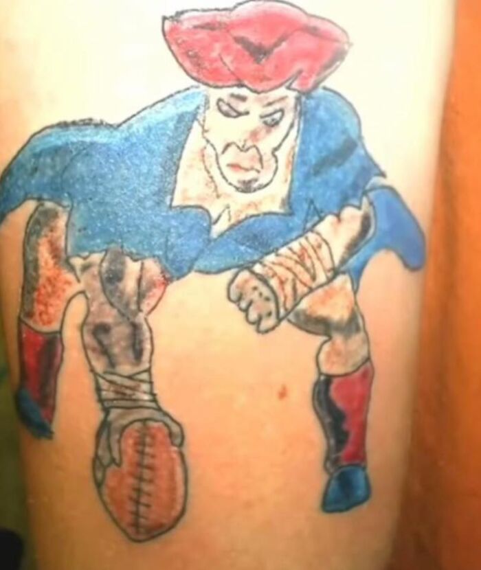 Tattoo of a poorly drawn football player with red and blue colors, showcasing one of the worst tattoos seen online.