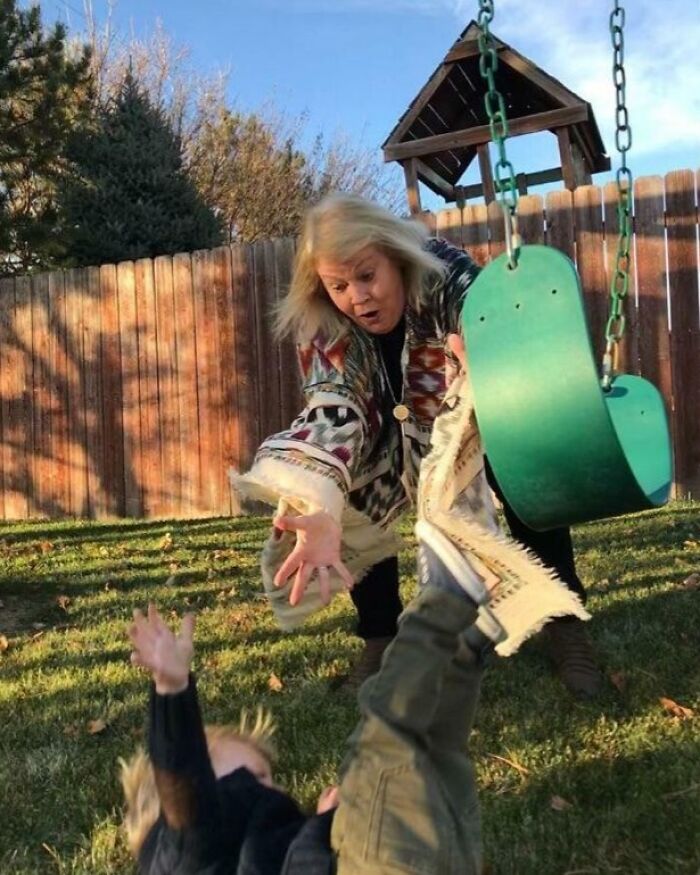 Woman reaching to catch child falling from swing in funny, interesting and weird pics taken at the perfect time.