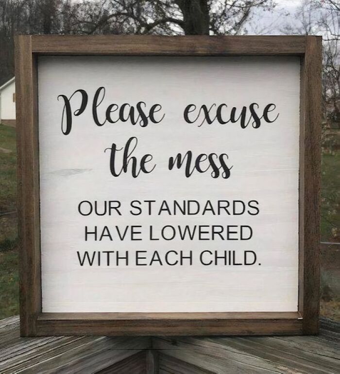 Wooden framed sign outdoor decor with funny relatable meme about parenting and mess standards lowering with each child.
