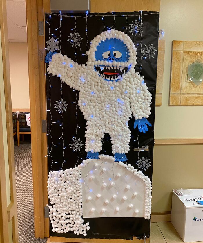 Creative workplace Christmas decorations featuring a cotton ball yeti with lights, showcasing unique festive office decor ideas.