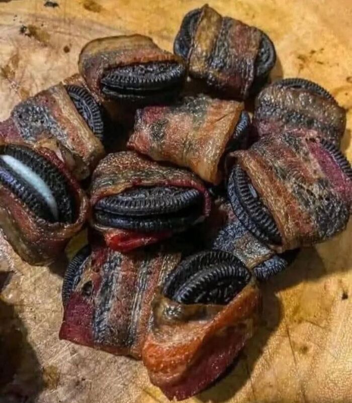 Bacon-wrapped Oreos on a wooden board, an unusual food combo featured in food pics that deserve to be shamed online.