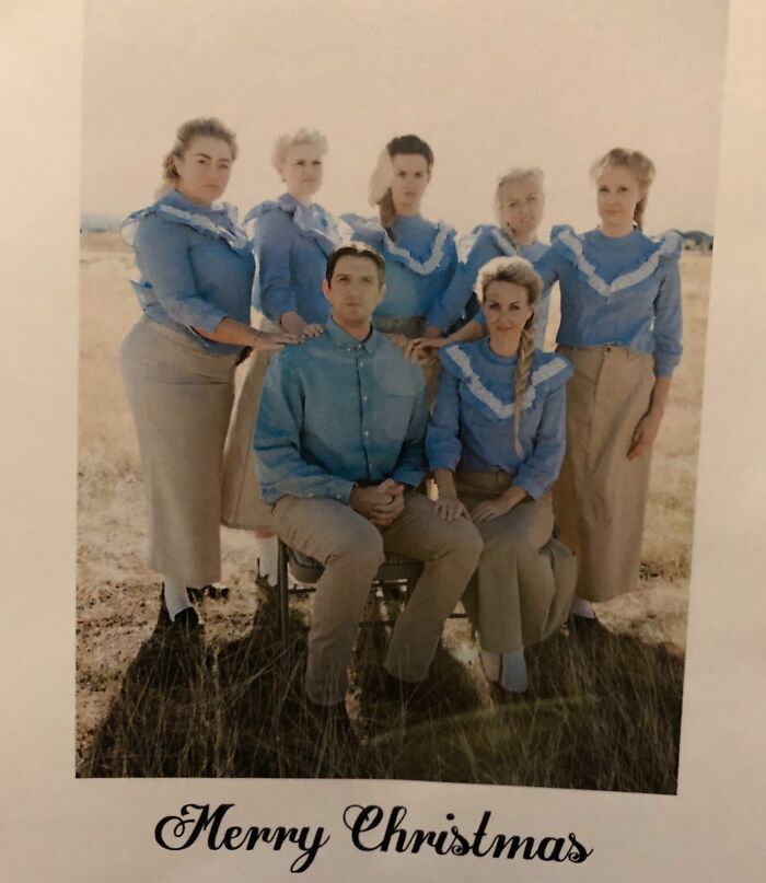Awkward family Christmas photo with matching outfits and serious expressions in an outdoor setting.