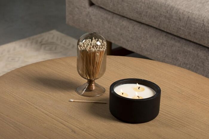 Modern candle and matchstick holder on a wooden table, ideal unique gifts for the person who has everything.