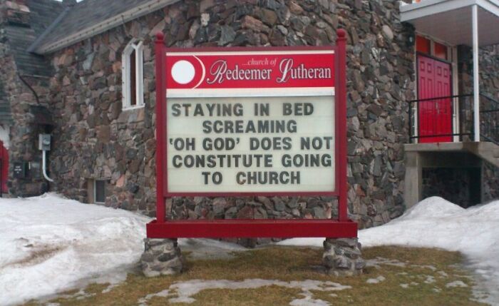 Church sign joke reading staying in bed screaming oh God does not constitute going to church on snowy lawn.