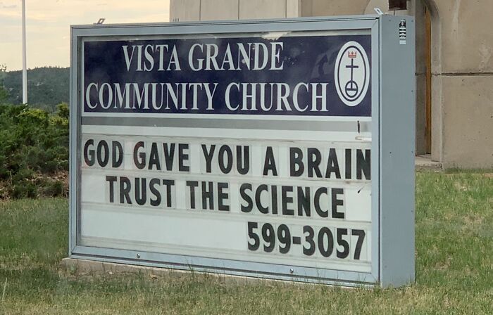 Church sign at Vista Grande Community Church with a humorous message encouraging trust in science and faith.