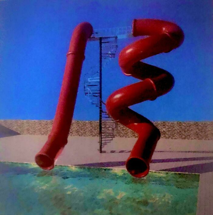 Red twisting water slides near a pool with a spiral staircase in a surreal liminal space resembling the backrooms.