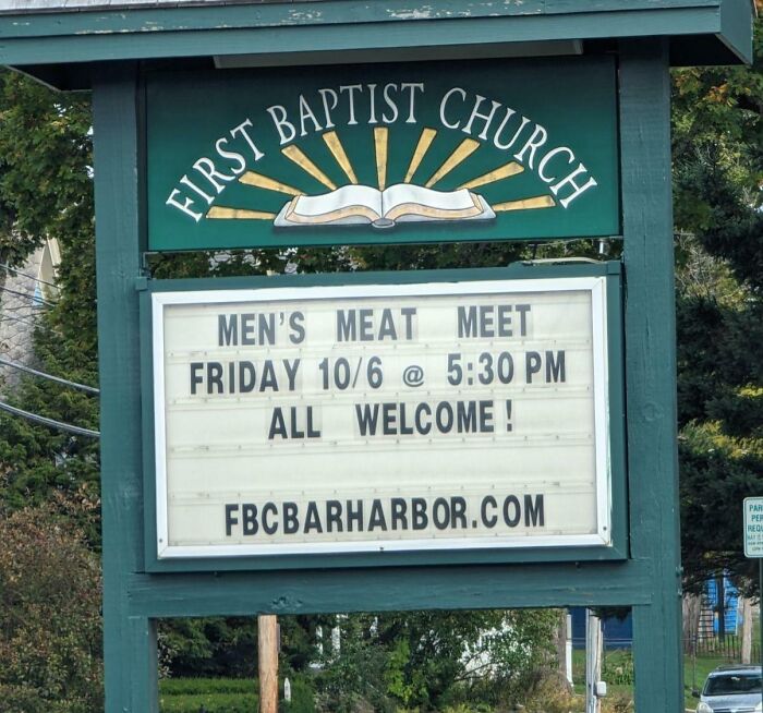 Church sign at First Baptist Church showing a humorous message about a men's meat meet event with date and time details.