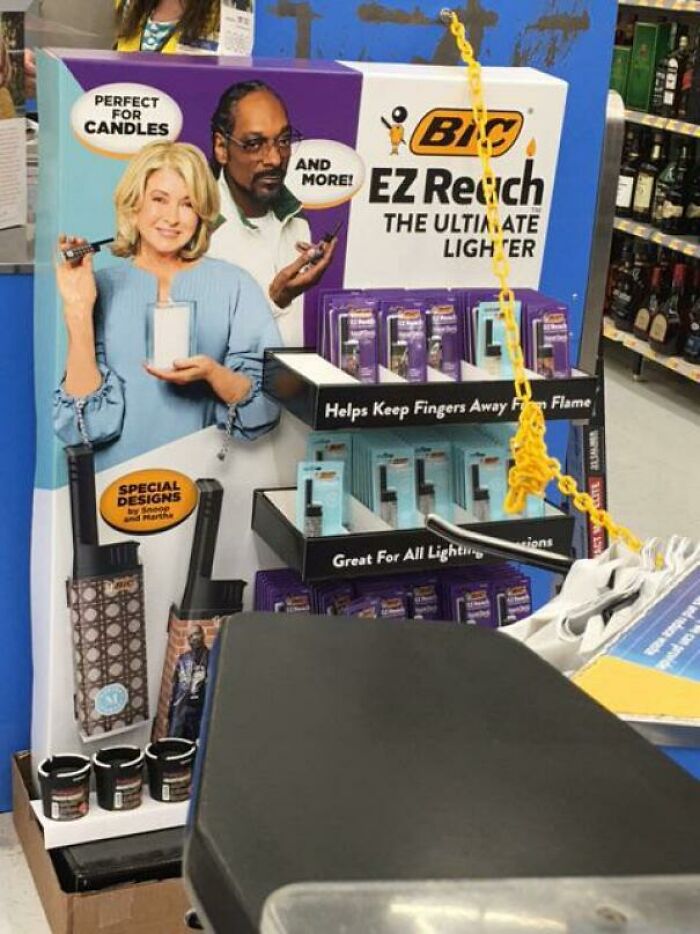 Walmart people display of Bic EZ Reach lighters with humorous photos of people holding lighters near candles.