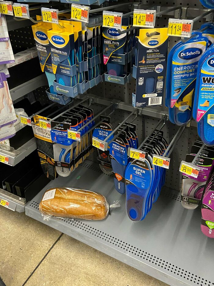Loaf of bread placed among Walmart people shoe insoles, creating a funny and confusing shopping display.
