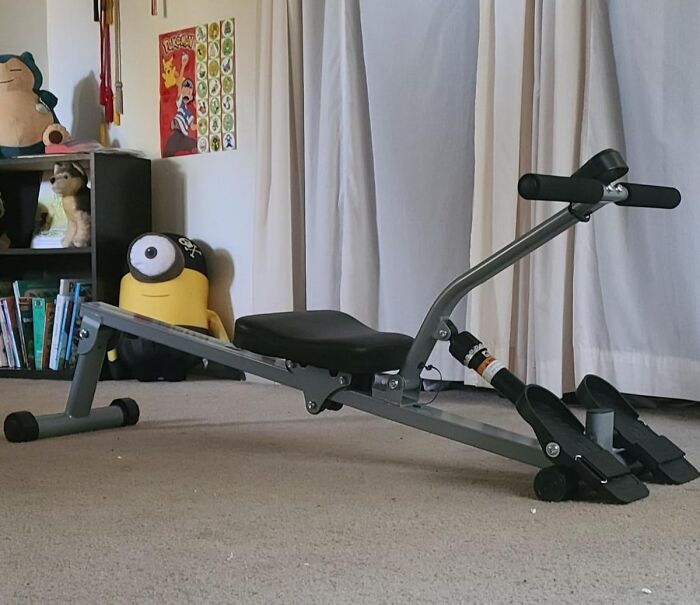 Home workout rowing machine in living room showing apartment friendly fitness equipment for smashing goals.