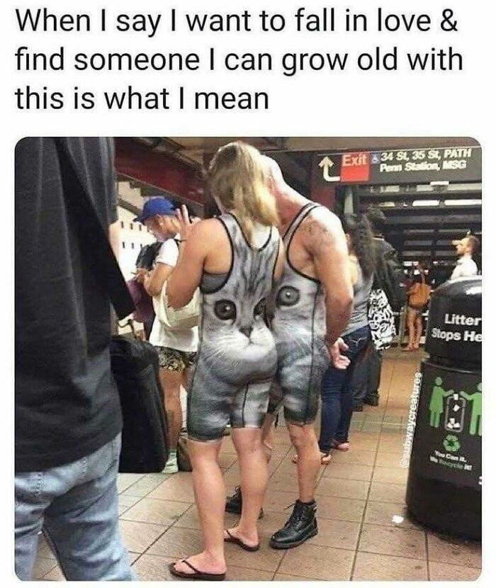 Couple wearing matching cat-themed outfits standing close in a busy subway station, a funny meme about love and connection.