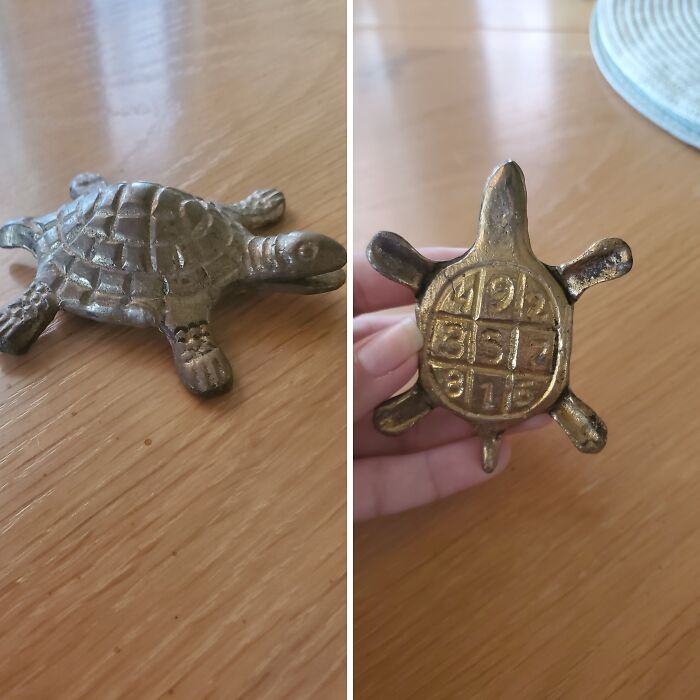 Small metal turtle figurine with a magic square on its underside, one of the most bizarre things received as Christmas gifts.