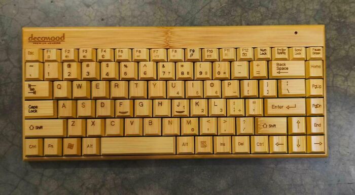 Compact wooden keyboard with bamboo keys and engraved letters, a unique and bizarre Christmas gift idea.