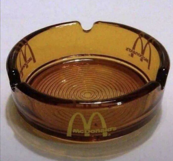 Brown vintage McDonalds branded glass ashtray with circular ridges inside, shown in a well-lit close-up photo.