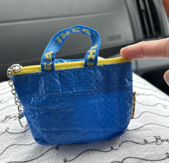 Mini blue woven bag with yellow zipper and strap, keychain attached, highlighting popular best sellers of 2025 trends.