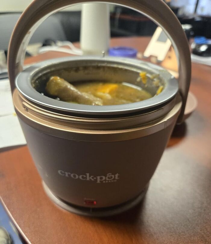 Small Crock-Pot slow cooker with food inside on a wooden table, showcasing a best seller in 2025 kitchen appliances.