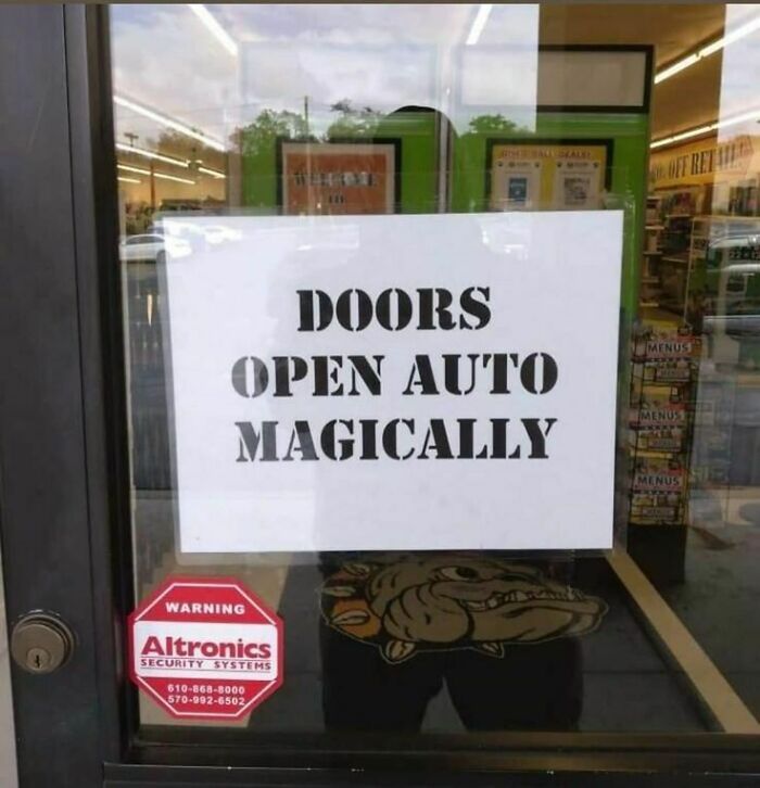 Funny stupid signs pics showing a door sign with the humorous typo saying doors open auto magically at an entrance.