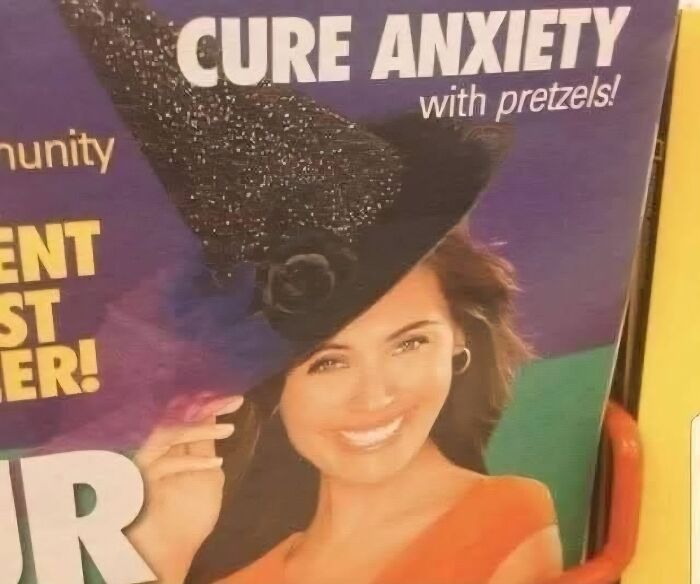 Smiling woman wearing a large black hat next to a sign claiming you can cure anxiety with pretzels, funny stupid signs pics.