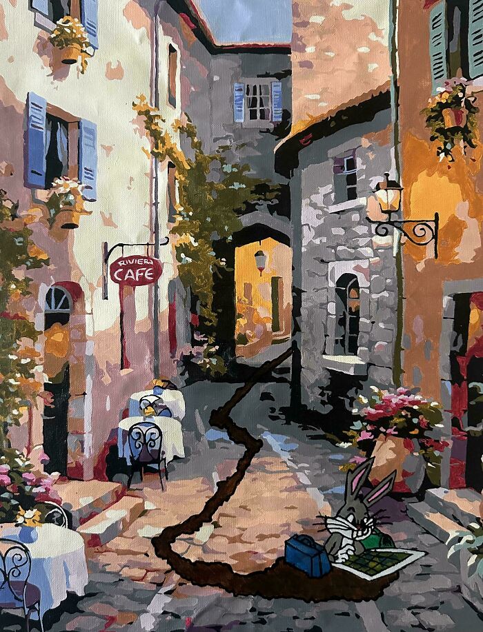 Painting of a quaint street café with a humorous twist featuring Bugs Bunny digging in the cobblestone path.
