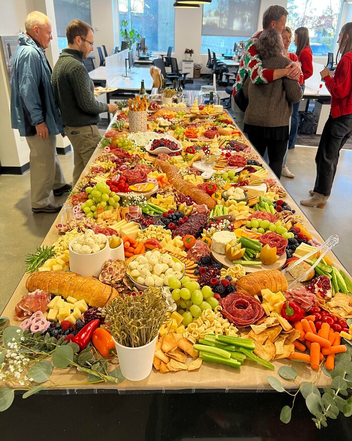 A festive holiday charcuterie spread with fruits, cheeses, and crackers, creating sweet moments to melt even the Grinchiest heart.