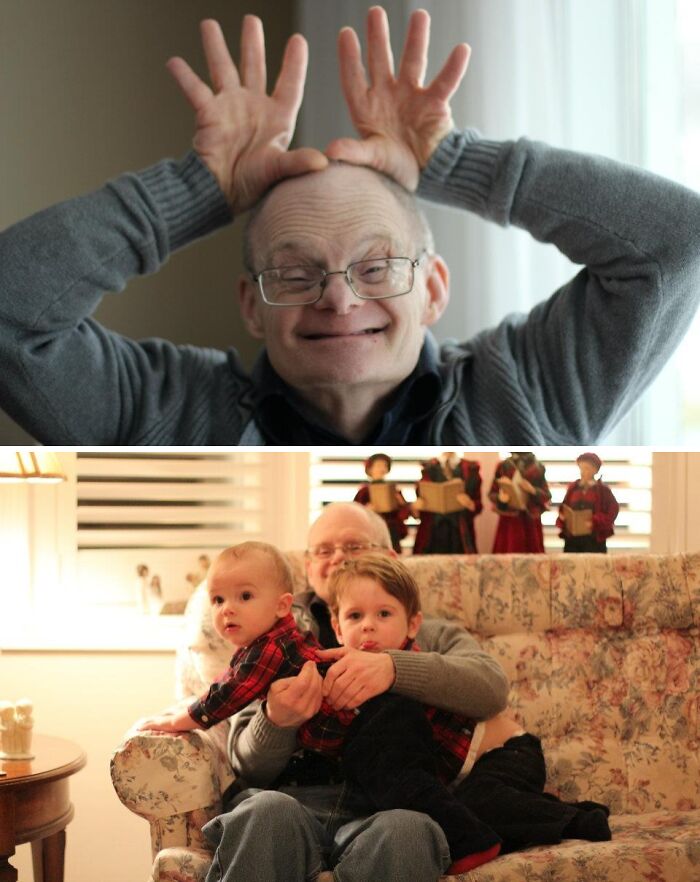 Elderly man making playful gesture and enjoying holiday moments with two young children on a cozy couch.