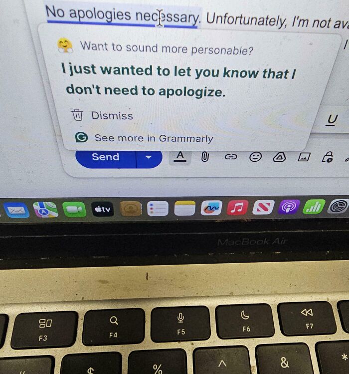 MacBook Air screen showing Grammarly suggestion over an email message, keyboard visible - Funny Pictures From 2025