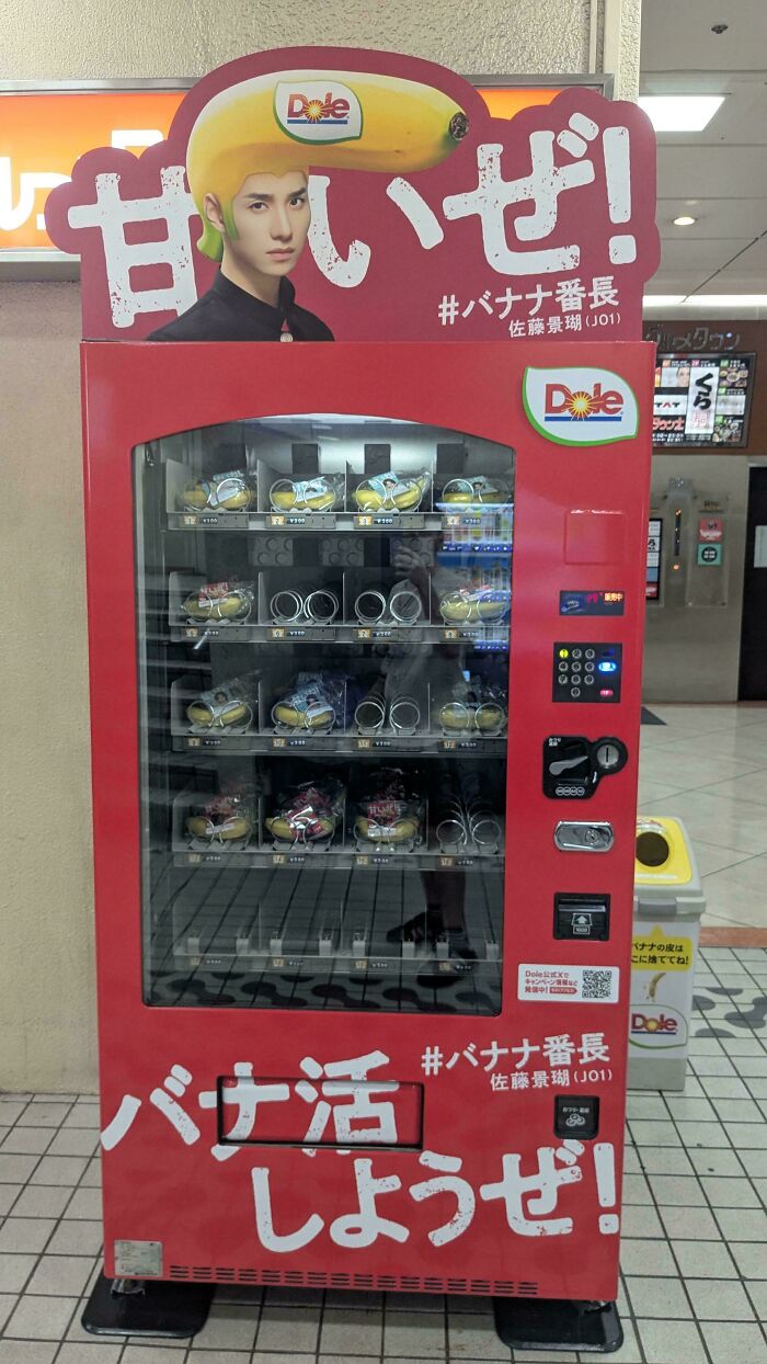 Red vending machine selling packaged bananas with Dole branding, showcasing an impressive things countries implemented innovation.
