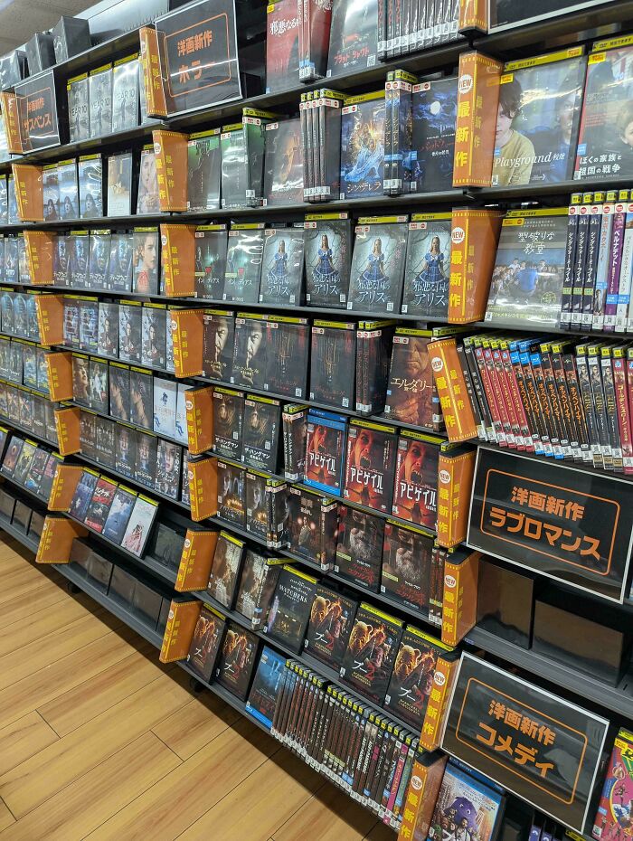 DVD store shelves neatly arranged with diverse movie collections, showcasing impressive things countries implemented that left people in awe.