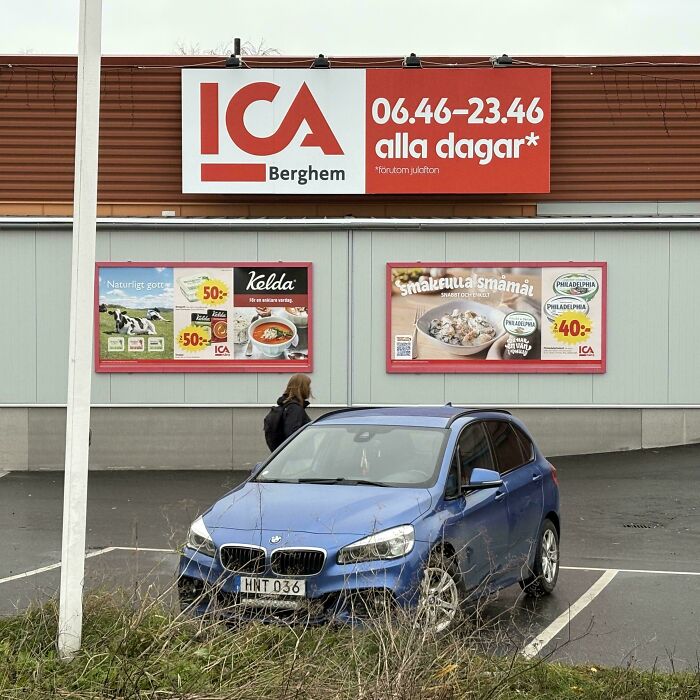 Blue BMW parked outside a Swedish ICA store showcasing impressive things countries implemented in everyday retail settings.