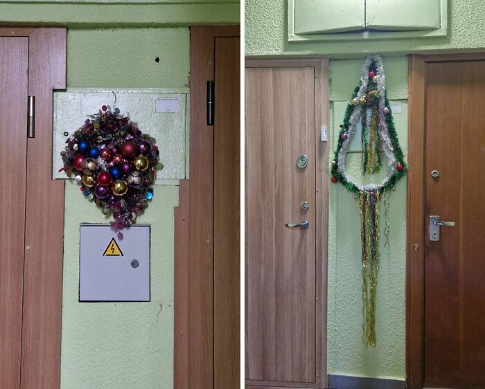 Unhinged Lithuanian Christmas decorations with colorful baubles and tinsel hanging in a plain apartment building hallway.