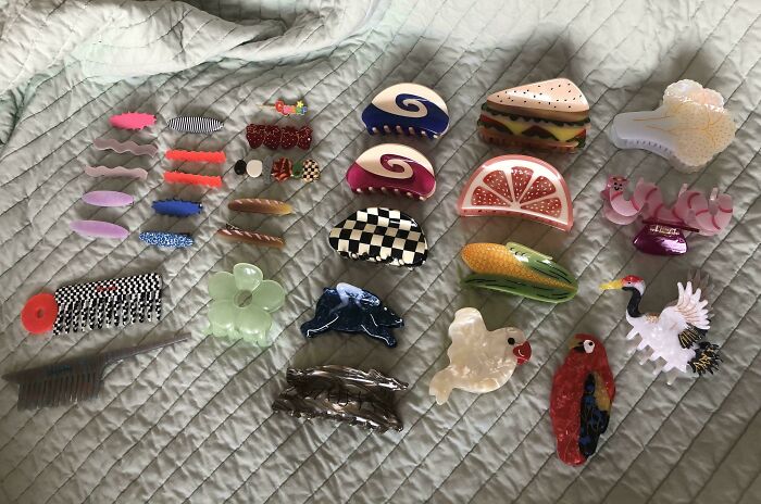 Various colorful hair clips and accessories laid out on a gray quilt, relating to men sharing insights about women.