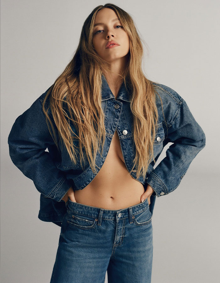 Sydney Sweeney in American Eagle denim outfit, posing confidently in a casual fashion photoshoot.