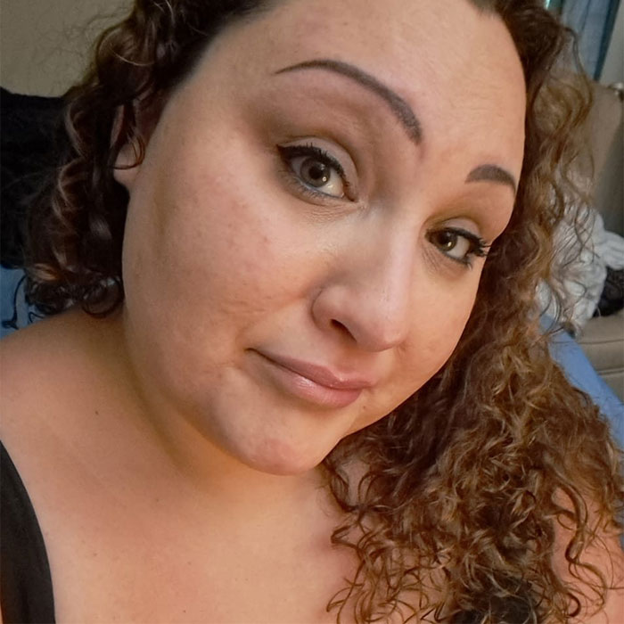 Close-up of a woman with curly hair and makeup, associated with two teens charged with homicide after brutal attack. Close-up of a woman with curly hair and makeup, associated with two teens charged with homicide after brutal attack.