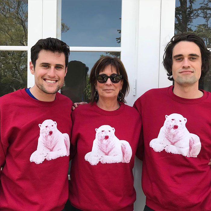Three people wearing matching red sweatshirts with polar bear prints, related to Rob Reiner&rsquo;s son arrested news.