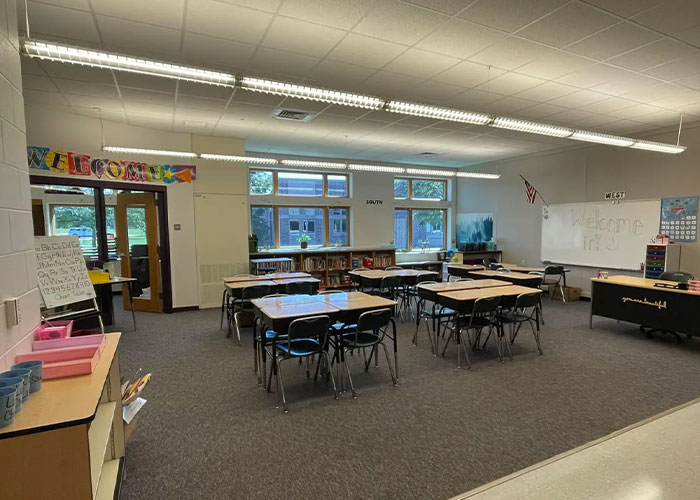 Empty classroom with desks and chairs arranged, related to teacher sending 35K texts to student and her fate revealed.