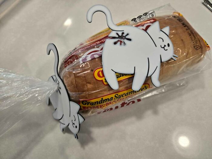 Cat-shaped bread bag clips holding a loaf of Grandma Sycamore's bread, a popular best seller in 2025.