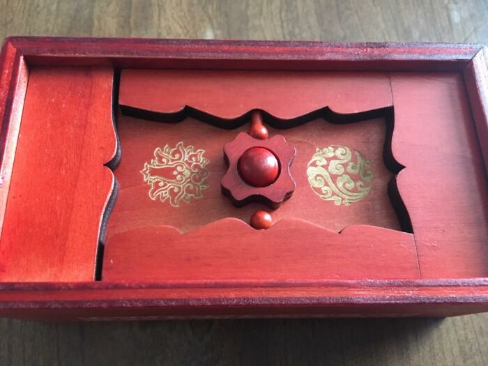 Decorative red wooden box with intricate gold designs, a unique gear-shaped k**b, a popular gift teens are begging Santa for.