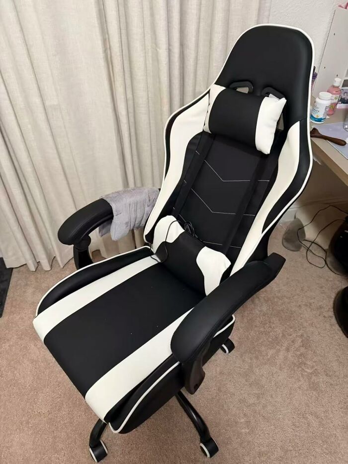 Black and white ergonomic gaming chair with lumbar support and headrest, a popular gift teens are begging Santa for this year.