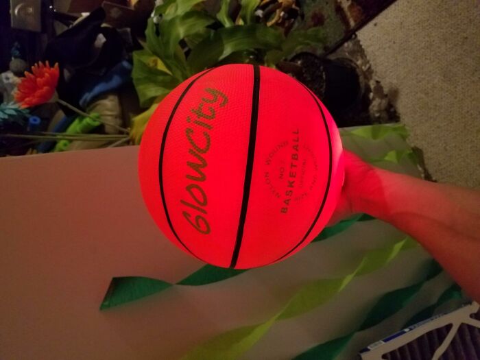 Glowing basketball held in hand, popular gift idea for teens seeking unique and fun holiday presents.