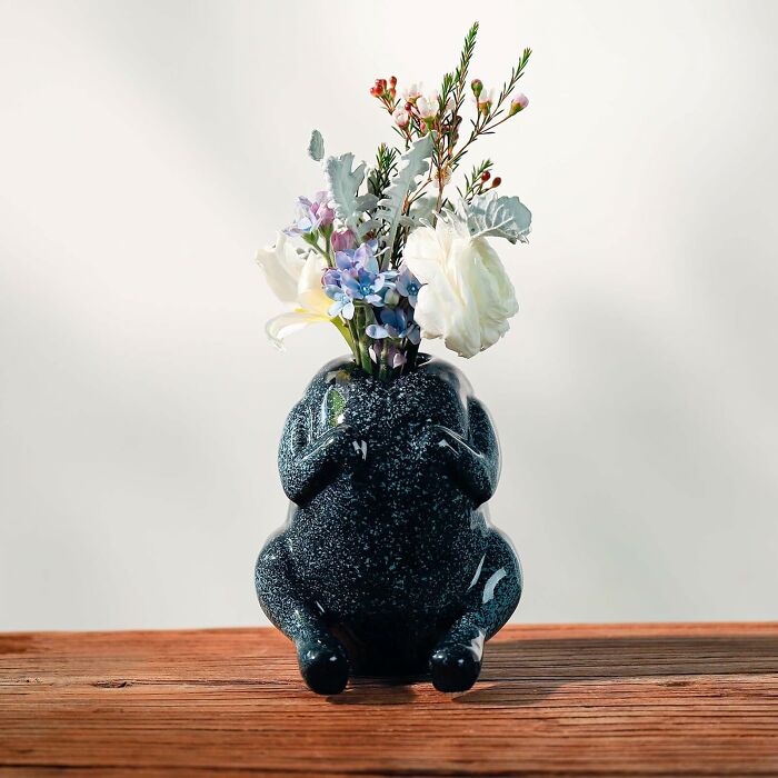 Ceramic quirky gift vase shaped like a sitting figure holding flowers, perfect for unhinged friend’s unique taste.