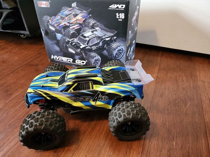 Remote control monster truck toy on wooden floor with box in background, popular gifts teens are begging Santa for this year