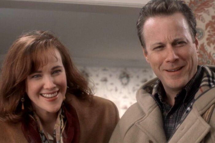 Adult couple from Home Alone smiling indoors, related to Macaulay Culkin addressing Kevin&rsquo;s dad&rsquo;s job theory.