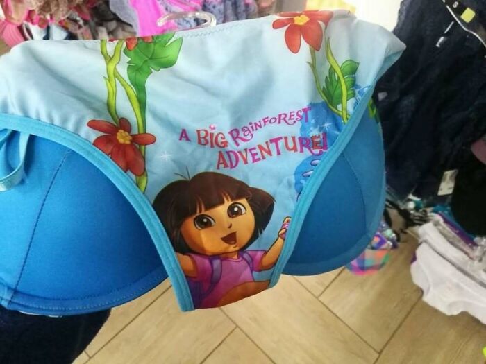 Blue bra with attached children's underwear featuring a cartoon character, creating a random funny visual surprise.