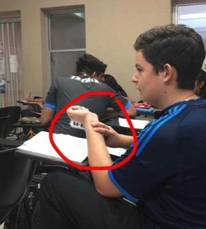 Student in classroom appearing to have an upside-down foot due to a visual trick in random pics that make you laugh.