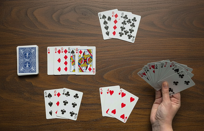 Playing a classic card game with multiple hands on a wooden table, highlighting the best party game experience.
