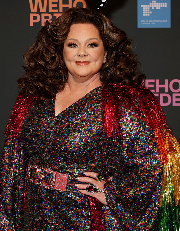 Melissa McCarthy wearing a colorful sequin dress with red fringe, showcasing her jaw-dropping 95-pound weight loss.