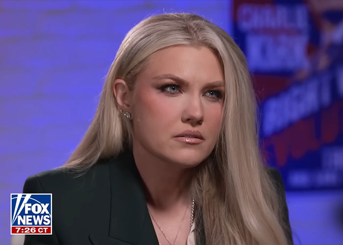 Erika Kirk in an interview setting with focused expression discussing husband Charlie's body slam as clip resurfaces.