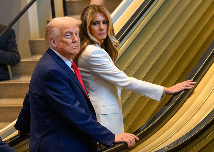 Donald Trump and Melania Trump on an escalator, photographed during a formal event related to Melania Trump's new documentary. Donald Trump and Melania Trump on an escalator, photographed during a formal event related to Melania Trump's new documentary.